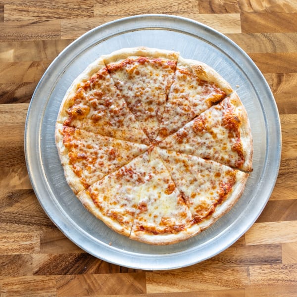 A whole cheese pizza, sliced into eight pieces, on a metal pizza pan.
